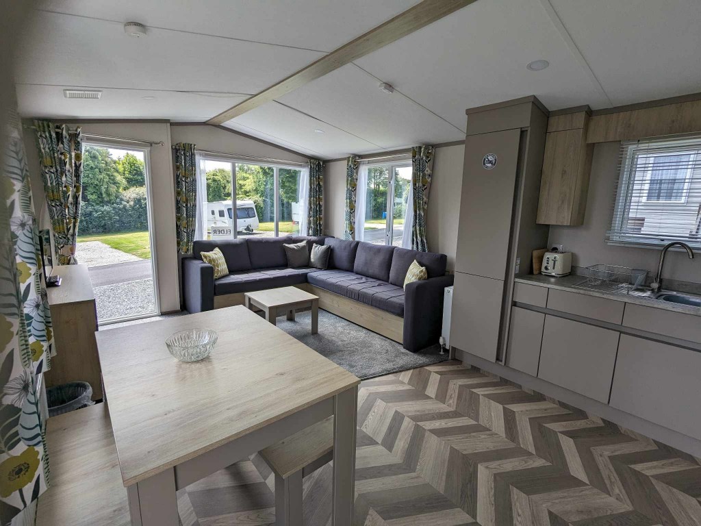 Looking at the kitchen lounge and dining area in a open plan static holiday home in Newquay Cornwall